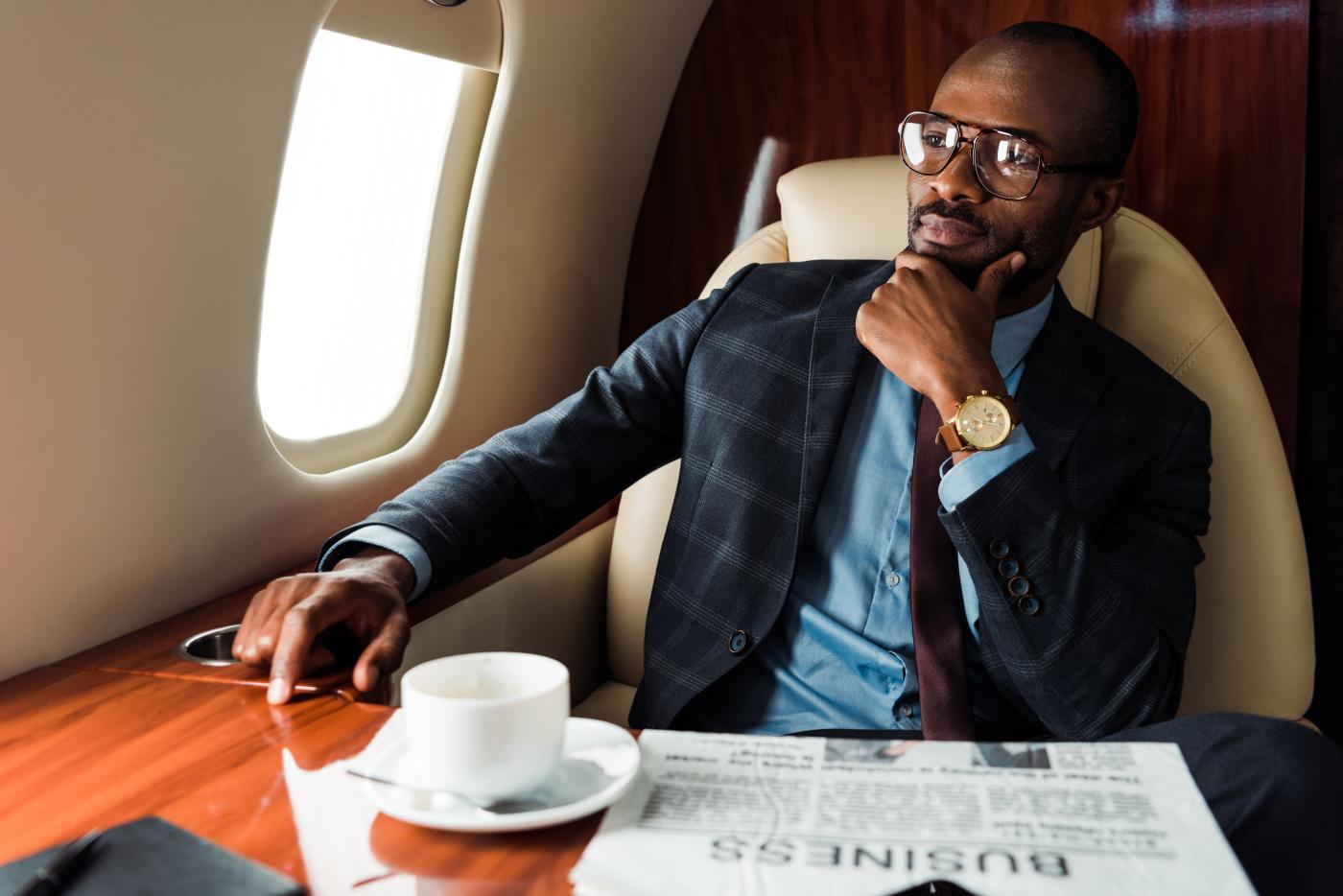 A wealthy man sitting in an airplane.